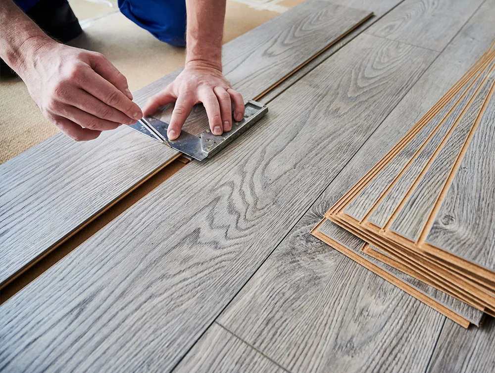 Contractor installing flooring on a jobsite